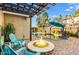 Relaxing backyard oasis with a fire pit, pool, pergola, and lounge chairs for outdoor enjoyment at 18456 E Superstition Dr, Queen Creek, AZ 85142