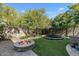 Landscaped backyard with a fire pit and trampoline at 18456 E Superstition Dr, Queen Creek, AZ 85142