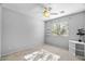 Bright bedroom with ceiling fan, window, and shelving at 18456 E Superstition Dr, Queen Creek, AZ 85142