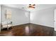 Bright bedroom with hardwood floors and a ceiling fan at 18456 E Superstition Dr, Queen Creek, AZ 85142