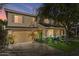 Two-story house with a beige facade, attached garage, and landscaping at 18456 E Superstition Dr, Queen Creek, AZ 85142