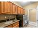 Laundry room with sink, cabinets and newer appliances at 18456 E Superstition Dr, Queen Creek, AZ 85142