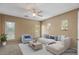 Comfortable living room with ample natural light, a ceiling fan, and plush seating at 18456 E Superstition Dr, Queen Creek, AZ 85142