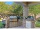 Outdoor kitchen with built-in grill and stone counter at 18456 E Superstition Dr, Queen Creek, AZ 85142