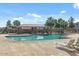 Community pool with a covered patio and lounge chairs at 18456 E Superstition Dr, Queen Creek, AZ 85142