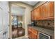 Convenient wet bar with wine cooler and granite countertop at 18456 E Superstition Dr, Queen Creek, AZ 85142