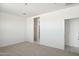 Spacious bedroom with carpet flooring and access to a bathroom and closet at 25380 W Sunland Ave, Buckeye, AZ 85326