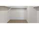 Large walk-in closet with shelves and hanging rods at 25380 W Sunland Ave, Buckeye, AZ 85326