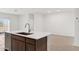 Kitchen island with sink and white countertop at 25380 W Sunland Ave, Buckeye, AZ 85326