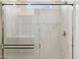 Shower with glass enclosure and marble tile at 25380 W Sunland Ave, Buckeye, AZ 85326