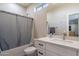 Clean bathroom with white vanity, tub shower combo, and gray accents at 2743 N Lema Dr, Mesa, AZ 85215