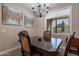 Elegant dining room with dark wood table and chandelier at 2743 N Lema Dr, Mesa, AZ 85215