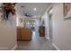 View into living room from entryway, showing a leather couch and a ceiling fan at 2743 N Lema Dr, Mesa, AZ 85215