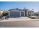 Two-car garage, gray exterior, and a landscaped front yard with artificial turf at 2743 N Lema Dr, Mesa, AZ 85215
