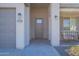 Gray front door, two-car garage, and a small covered porch at 2743 N Lema Dr, Mesa, AZ 85215
