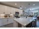 Modern kitchen with white cabinets, quartz countertops, and stainless steel appliances at 2743 N Lema Dr, Mesa, AZ 85215