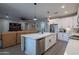 Modern kitchen with white cabinets, island, and stainless steel appliances at 2743 N Lema Dr, Mesa, AZ 85215