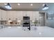 Modern kitchen with white cabinets, quartz countertops, and stainless steel appliances at 2743 N Lema Dr, Mesa, AZ 85215