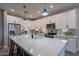 Modern kitchen with white cabinets, quartz countertops, and stainless steel appliances at 2743 N Lema Dr, Mesa, AZ 85215