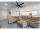 Open living room with sectional couch, ceiling fan, and view of the kitchen at 2743 N Lema Dr, Mesa, AZ 85215