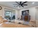 Spacious living room with leather sofas, large TV, and sliding glass doors leading to a patio at 2743 N Lema Dr, Mesa, AZ 85215
