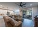 Open living room with a large sectional couch, and view into the kitchen at 2743 N Lema Dr, Mesa, AZ 85215