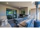 Spacious covered patio with seating, grill, and sliding glass doors at 2743 N Lema Dr, Mesa, AZ 85215