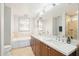 Elegant bathroom with double sinks, soaking tub, and separate shower at 310 S 4Th St # 1504, Phoenix, AZ 85004