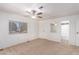 Bedroom with ceiling fan, carpet, and access to bathroom at 430 S 81St Pl, Mesa, AZ 85208