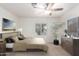 Virtually staged main bedroom with ceiling fan and large window at 430 S 81St Pl, Mesa, AZ 85208