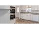 Bright kitchen with double oven, white cabinets, and tile flooring at 430 S 81St Pl, Mesa, AZ 85208