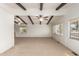 Living room featuring wood beam accents and ceiling fan at 430 S 81St Pl, Mesa, AZ 85208