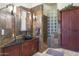 Bathroom with walk-in shower, soaking tub, and dark vanity at 9968 W Jj Ranch Rd, Peoria, AZ 85383