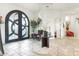 Impressive entryway with arched doors, elegant tile flooring, and a stylish console table at 9968 W Jj Ranch Rd, Peoria, AZ 85383