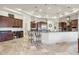Open concept kitchen with large island, breakfast bar, and high-end appliances at 9968 W Jj Ranch Rd, Peoria, AZ 85383