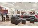 Spacious living area with a large sectional sofa and adjacent bar area at 9968 W Jj Ranch Rd, Peoria, AZ 85383