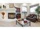 Cozy sitting area with a fireplace and built-in wet bar at 9968 W Jj Ranch Rd, Peoria, AZ 85383