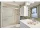Bathroom with a walk-in shower, updated vanity, and decorative sink at 10533 W Wheatridge Dr, Sun City, AZ 85373