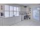 Well-equipped kitchen with ample counter space, white cabinetry and built-in desk at 10533 W Wheatridge Dr, Sun City, AZ 85373