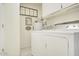 Bright laundry room with washer, dryer, and ample storage at 10533 W Wheatridge Dr, Sun City, AZ 85373