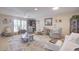 Bright and airy living room with comfortable seating and large windows at 10533 W Wheatridge Dr, Sun City, AZ 85373