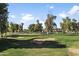 Scenic view of a lush green golf course with sand traps and mature trees at 10796 N 78Th St, Scottsdale, AZ 85260
