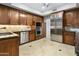 Modern kitchen with dark wood cabinets, granite countertops, and stainless steel appliances at 10796 N 78Th St, Scottsdale, AZ 85260
