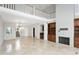 High-ceilinged living room with a large brick fireplace and loft view at 10796 N 78Th St, Scottsdale, AZ 85260