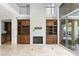 High-ceilinged living room with a large brick fireplace and built-in shelving at 10796 N 78Th St, Scottsdale, AZ 85260