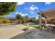 Spacious backyard with a swimming pool, patio furniture, and a covered patio at 13616 W San Miguel Ave, Litchfield Park, AZ 85340