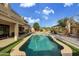 Landscaped backyard featuring a sparkling pool at 13616 W San Miguel Ave, Litchfield Park, AZ 85340
