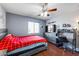 Bedroom with red bedding, ceiling fan, and built-in desk at 13616 W San Miguel Ave, Litchfield Park, AZ 85340