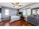Bedroom with a desk, dresser, and gray headboard at 13616 W San Miguel Ave, Litchfield Park, AZ 85340