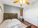 Bedroom with ceiling fan, wood floors, and double door closet at 13616 W San Miguel Ave, Litchfield Park, AZ 85340